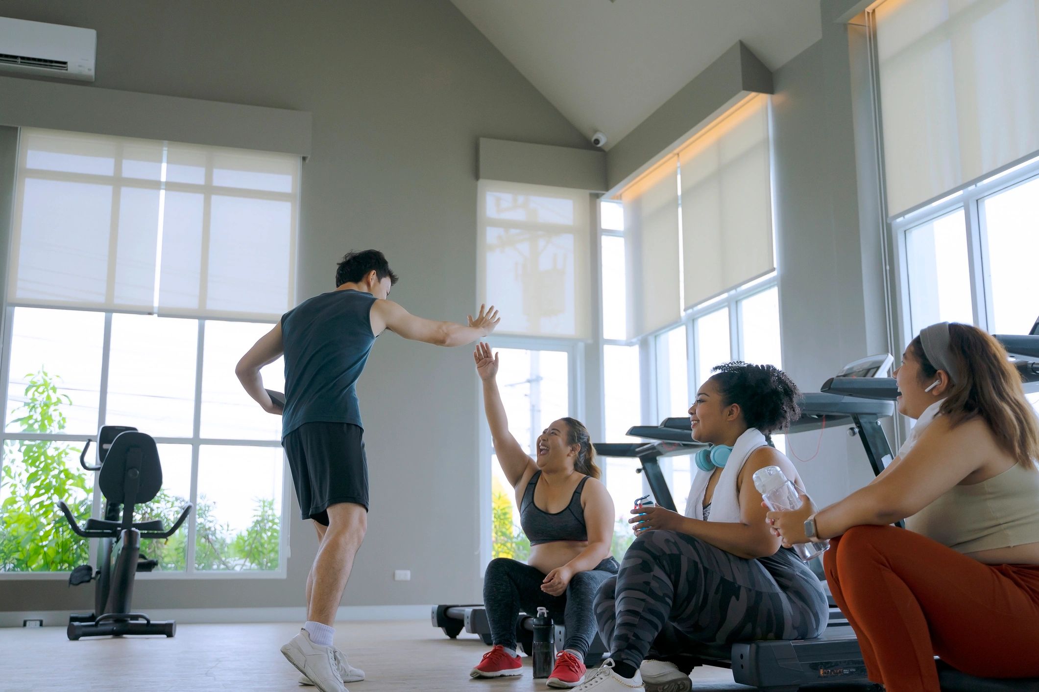 Group of women heading into a gym together, reflecting a supportive fitness community