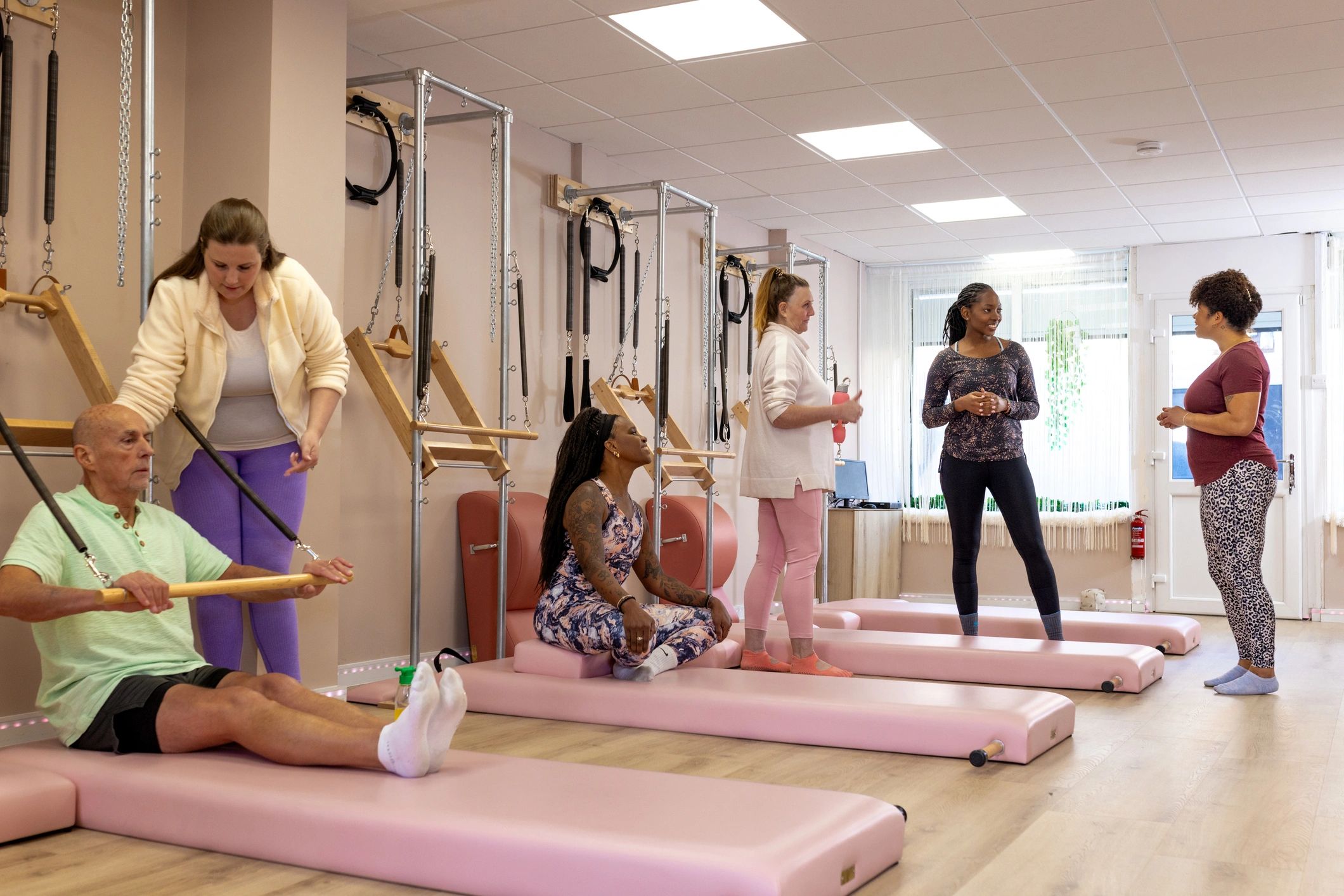 Group Lagree-style reformer class in a boutique fitness studio