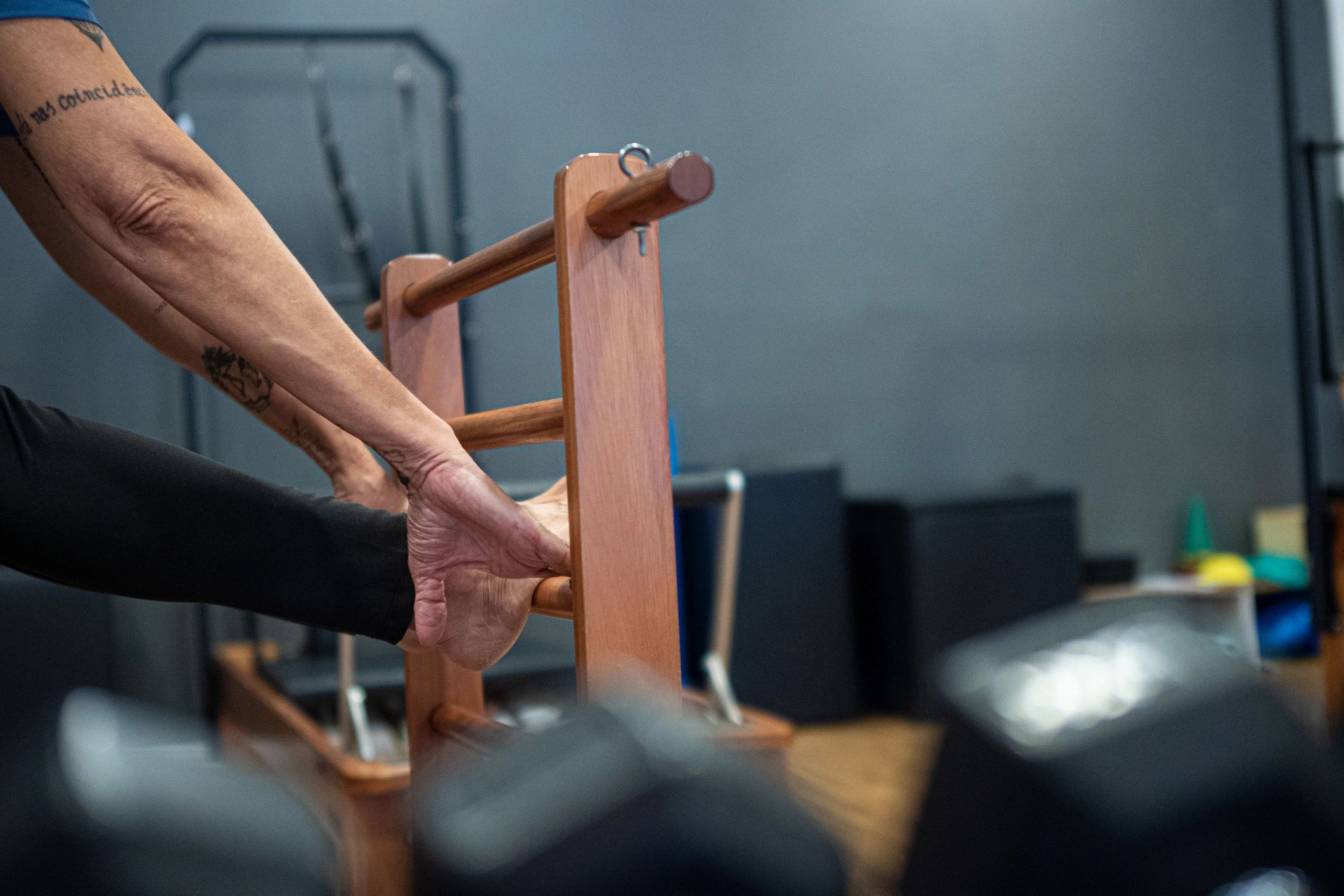 Woman stretching on a Pilates machine during a studio class